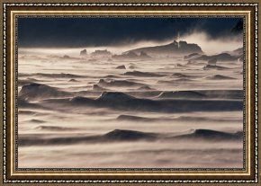 Cold Framed Paintings - Snow drift over winter sea ice by Antarctica
