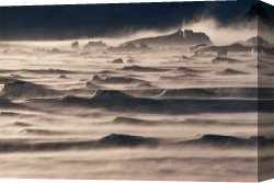 Cold Canvas Paintings - Snow drift over winter sea ice by Antarctica