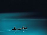 Raymond Gehman A Canoe Plies The Mirror Smooth Surface of Lake Louise
