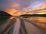 Raymond Gehman A Jet Boat Leaves a Wake in The Mackenzie River at Sunset