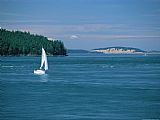 Western Prints - A Sailboat Travels Off Canadas Western Coast by Raymond Gehman