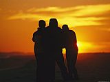 Raymond Gehman A Silhouetted Family Watches a Dramatic Sunset
