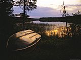 Raymond Gehman An Upturned Rowboat on The Shore of Iskwasum Lake at Sunset