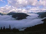 Raymond Gehman Clouds Shroud The Valley And Fill The Sky Along Logan Pass
