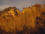 Resort Prints - Dawn Brightens Sandstone Cliffs at Natural Bridge State Resort Park by Raymond Gehman