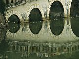 Calm Prints - Reflections of a Gracefully Arched Bridge in Calm Water by Raymond Gehman