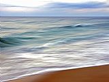 Raymond Gehman Teal And White Surf Flows on a Rust Colored Beach Under Blue Clouds