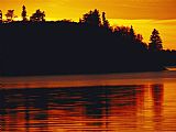 Raymond Gehman The Setting Sun Casts an Orange Glow Over Manitoba's White Lake
