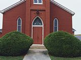 Red Doors Prints - Walkway And Front Door of a Red Brick Church by Raymond Gehman